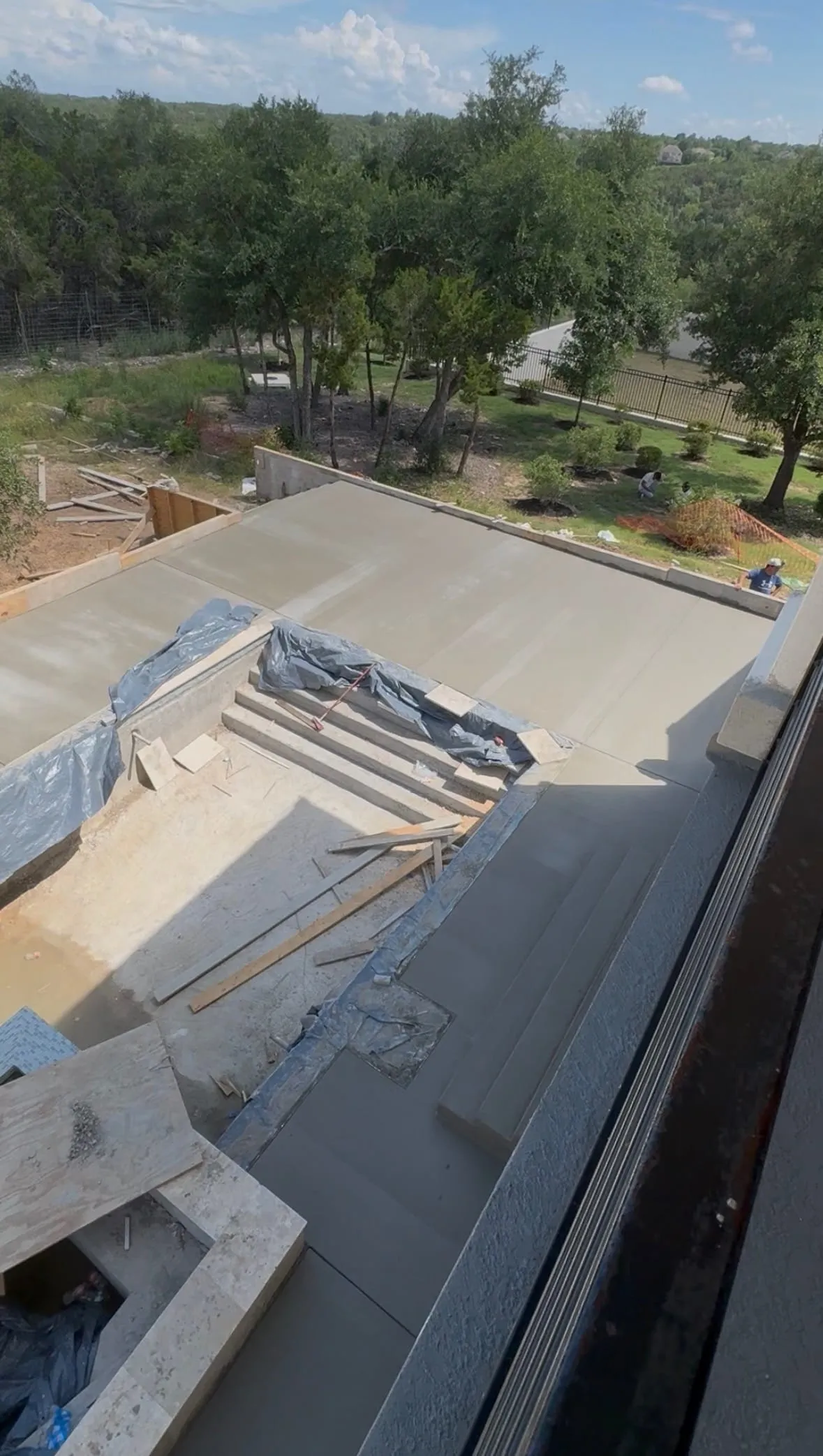 Broom-finish concrete patio surrounding pool