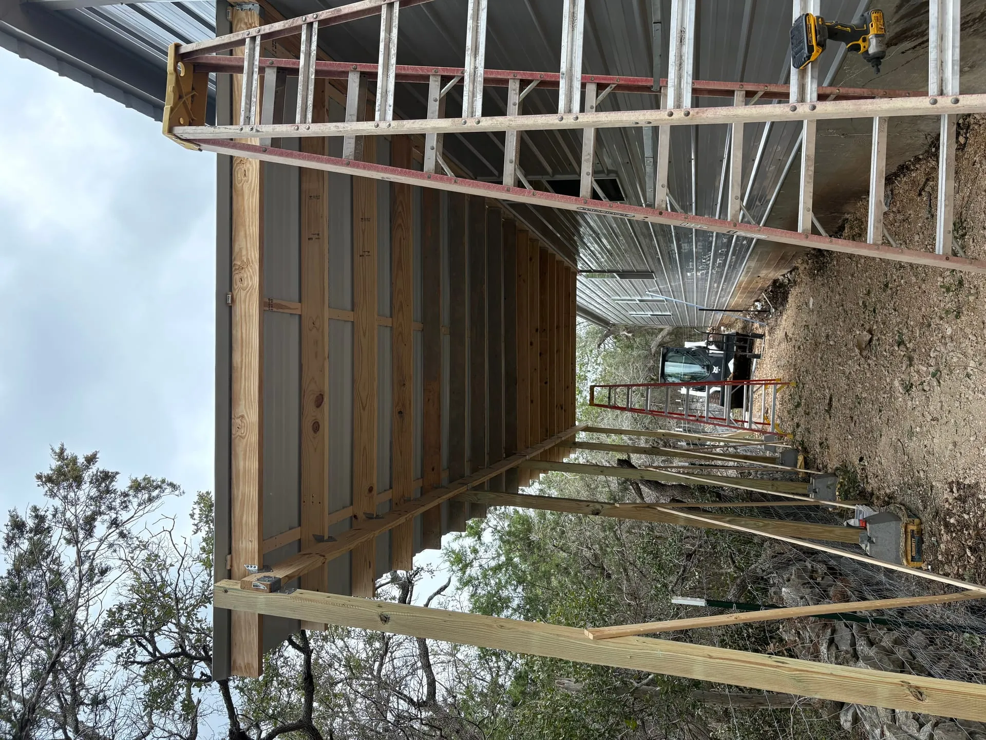 During construction photo showing framing progress for side porch storage enclosure
